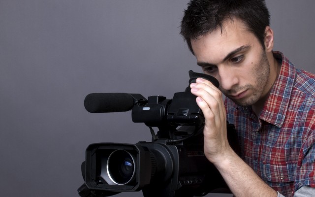young-man-with-video-camcorder-l