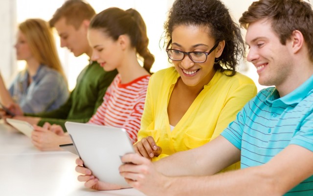 smiling-students-looking-at-tablet-pc-at-school-m-1721